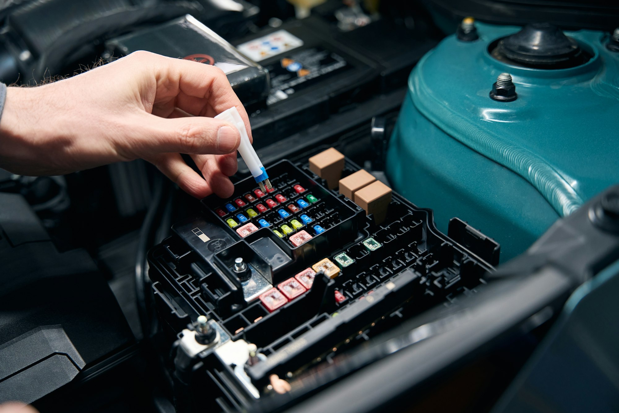 Man inspecting technical condition of car fuse