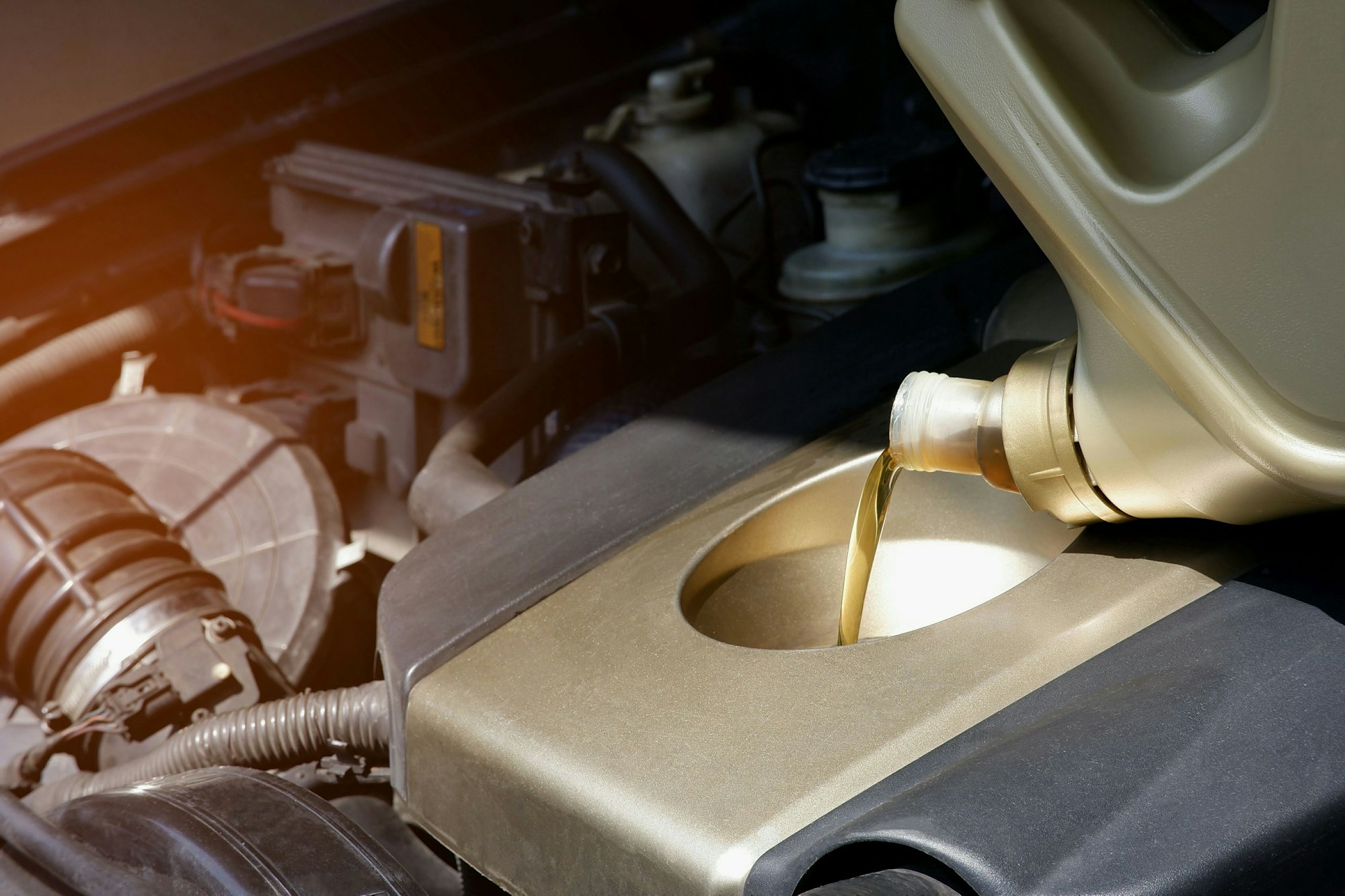 refueling and pouring engine oil into the car engine