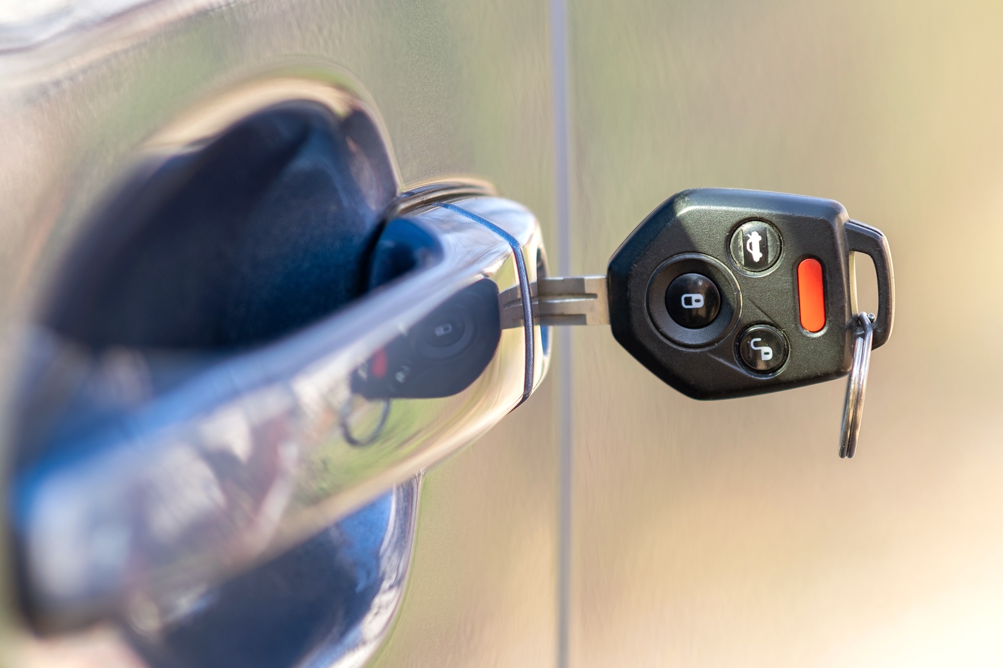 Close up of car door with key sticking out of the lock. Concept of process opening or closing