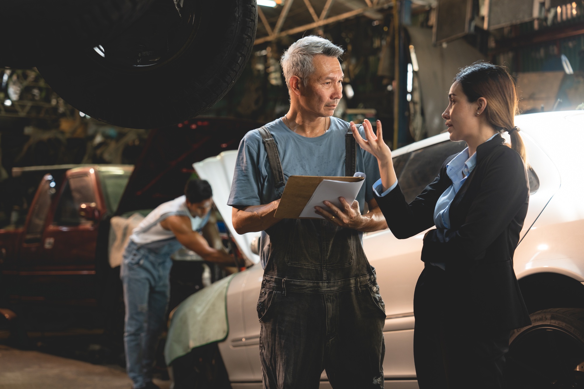 customer making inspection check to a car engine repair occupation job at garage service