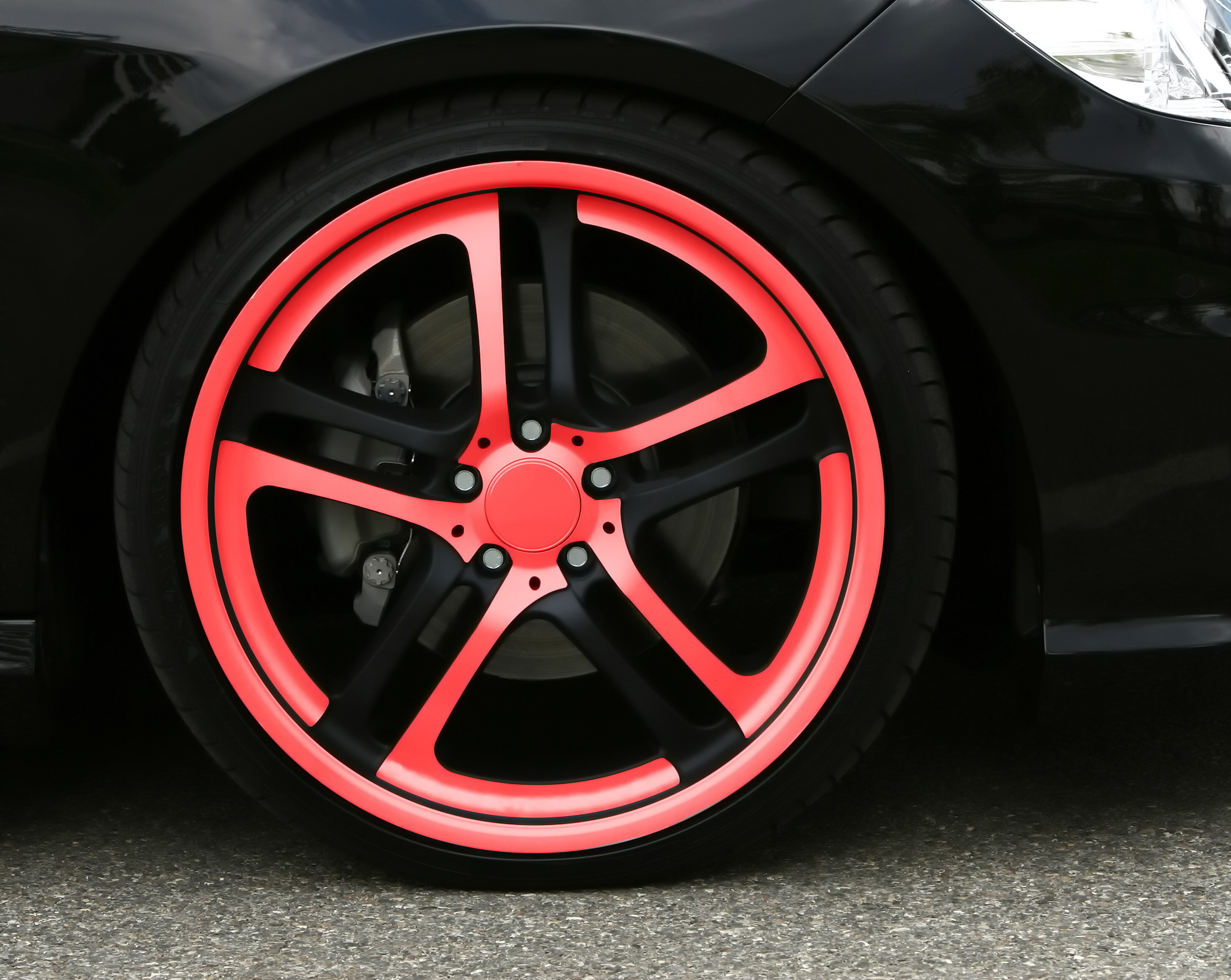 Stylish car wheel with red accents