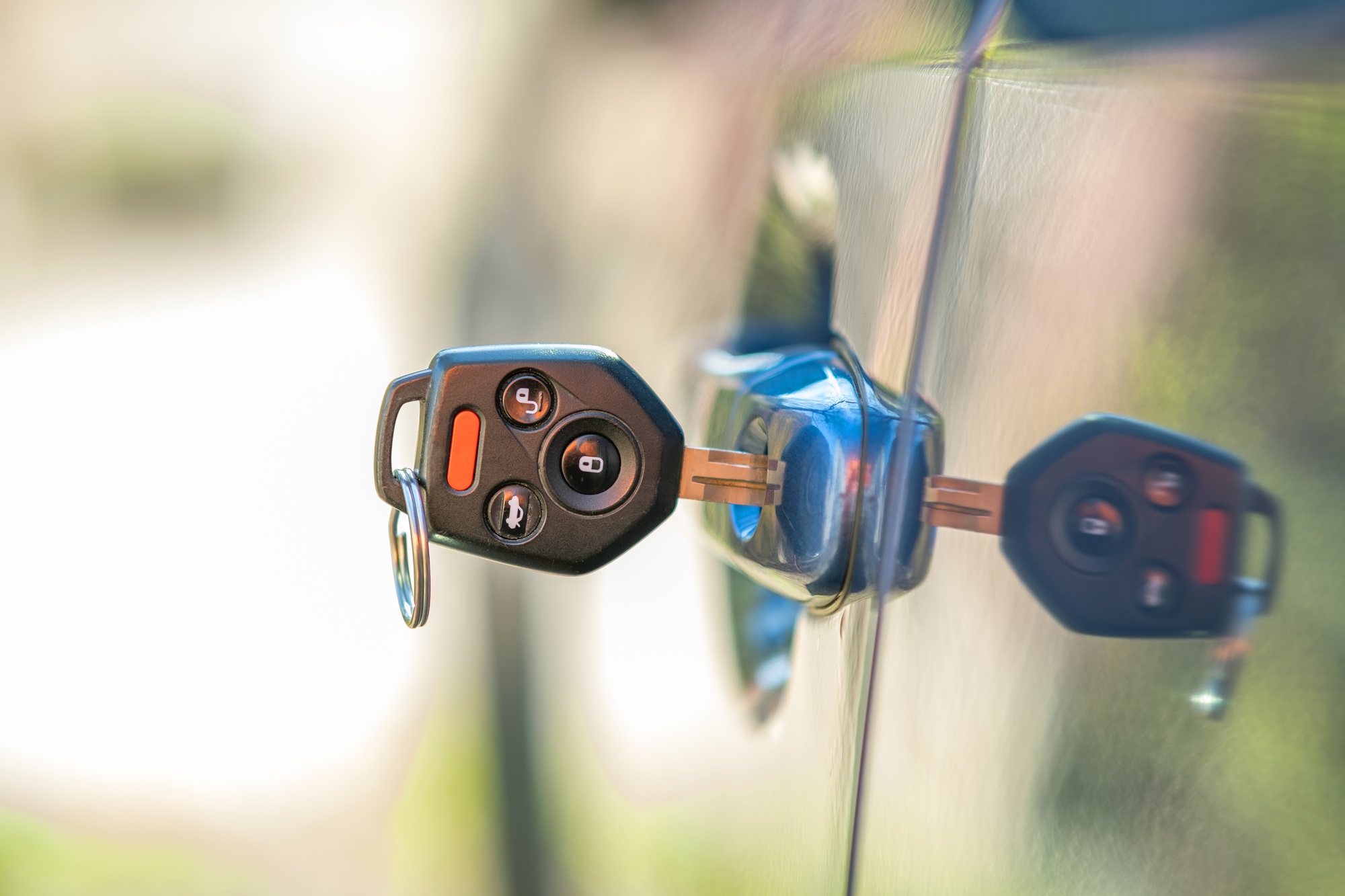 Close up of car door with key sticking out of the lock. Concept of process opening or closing